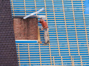 Bricklayer on very steep roof in danger of falling