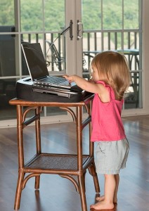 Young baby girl playing with laptop