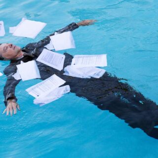 Drowning in paperwork concept photo