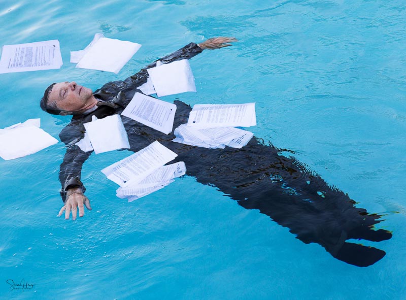 Drowning in paperwork concept photo