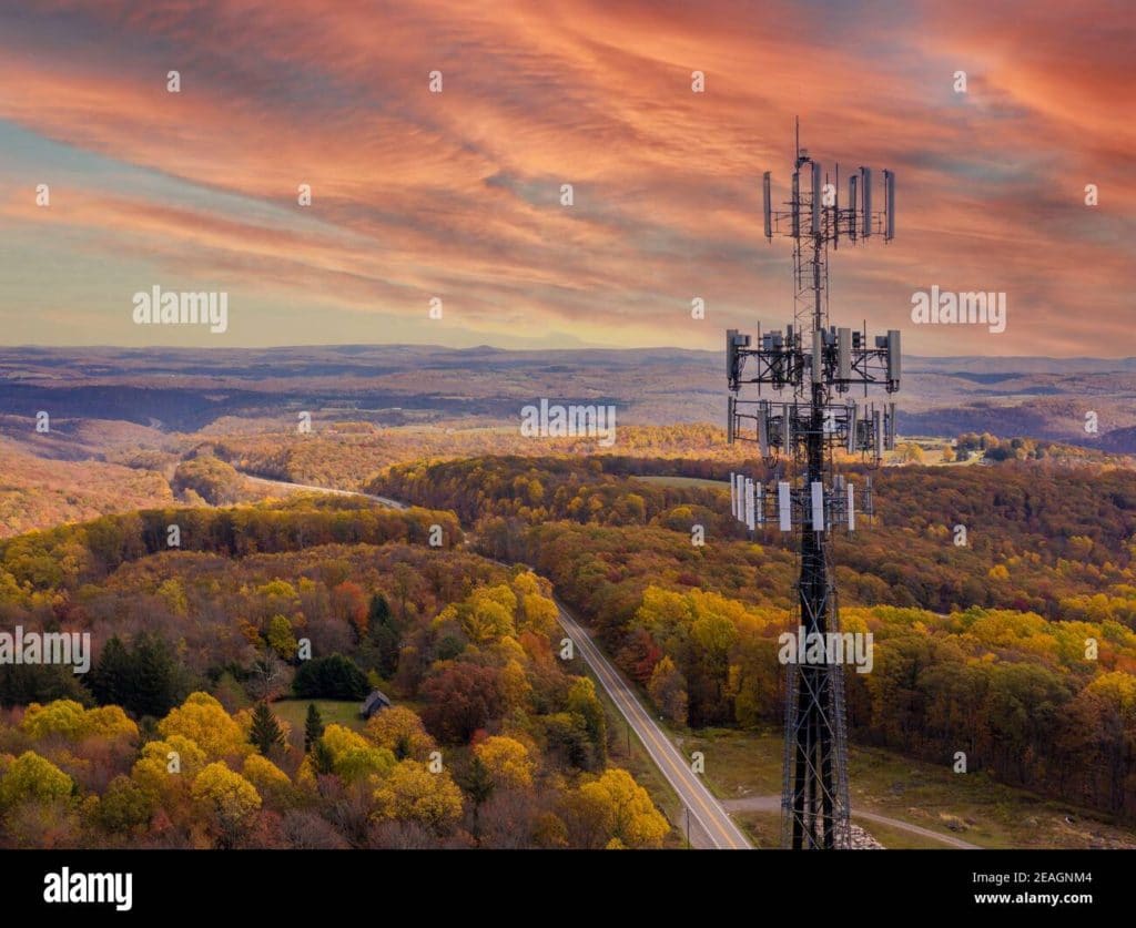 Sunset behind mobile or cellphone tower in rural area