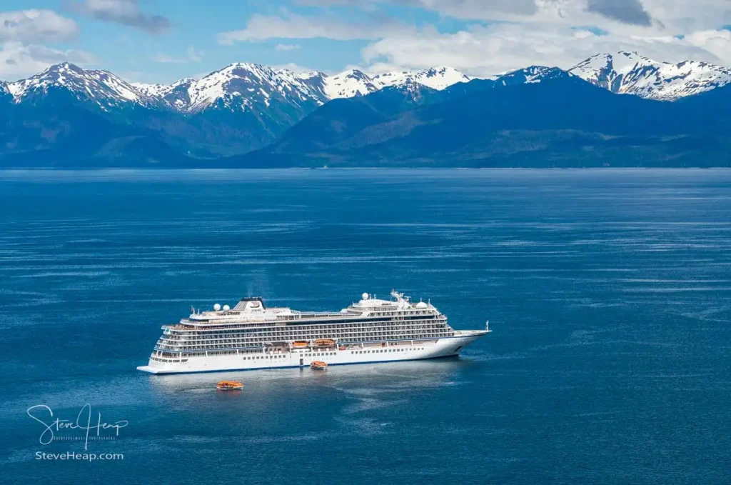 Viking Orion anchored in Alaska with snow covered mountains behind